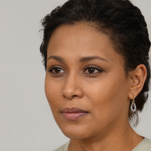 Neutral black young-adult female with medium  brown hair and brown eyes