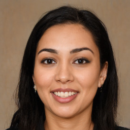 Joyful latino young-adult female with long  brown hair and brown eyes