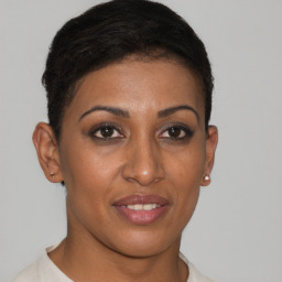 Joyful black young-adult female with short  brown hair and brown eyes