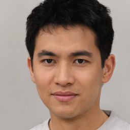 Joyful asian young-adult male with short  black hair and brown eyes