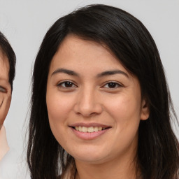 Joyful asian young-adult female with long  brown hair and brown eyes