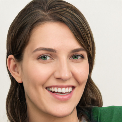 Joyful white young-adult female with long  brown hair and green eyes