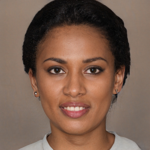 Joyful latino young-adult female with short  brown hair and brown eyes