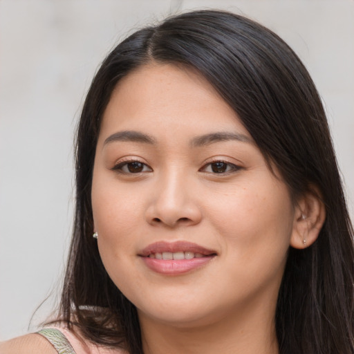 Joyful asian young-adult female with long  brown hair and brown eyes