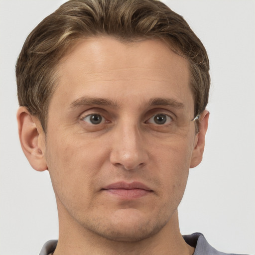 Joyful white adult male with short  brown hair and grey eyes