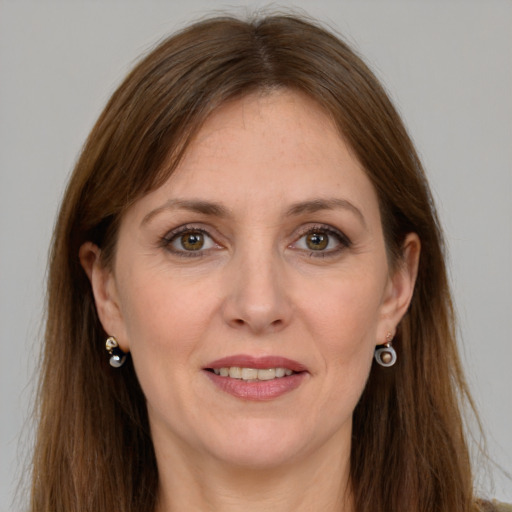 Joyful white adult female with long  brown hair and grey eyes