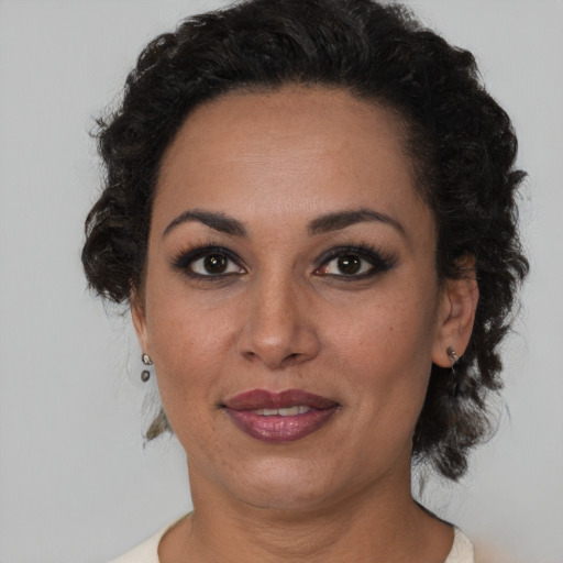 Joyful black adult female with short  brown hair and brown eyes