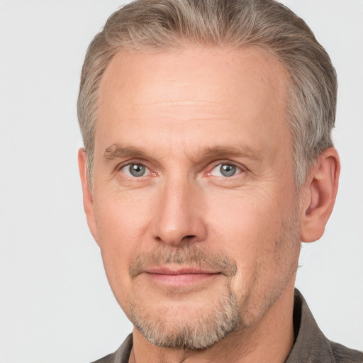 Joyful white adult male with short  brown hair and grey eyes