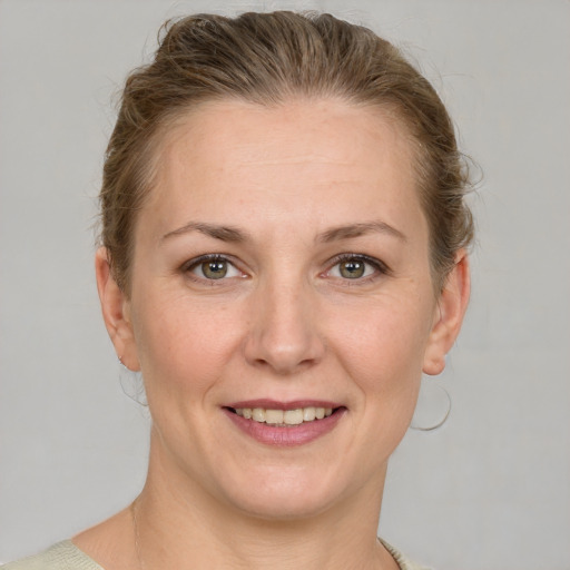 Joyful white adult female with short  brown hair and grey eyes