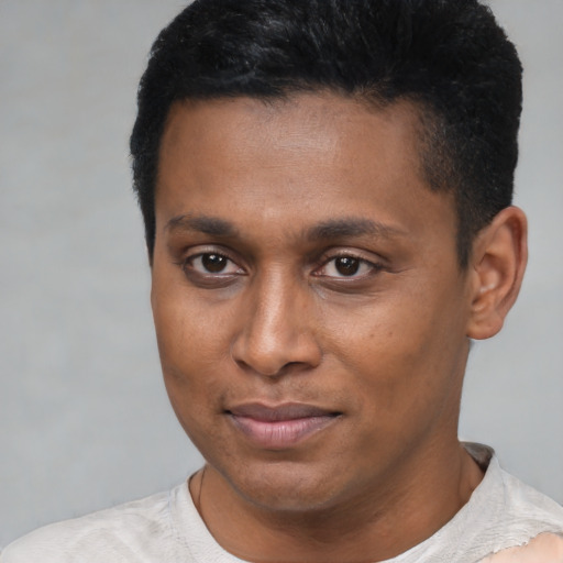Joyful latino young-adult male with short  brown hair and brown eyes