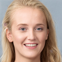 Joyful white young-adult female with long  brown hair and blue eyes