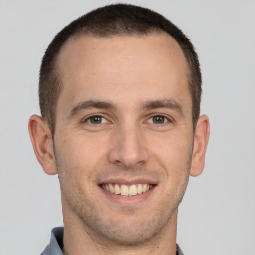 Joyful white young-adult male with short  brown hair and brown eyes