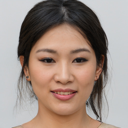 Joyful asian young-adult female with medium  brown hair and brown eyes