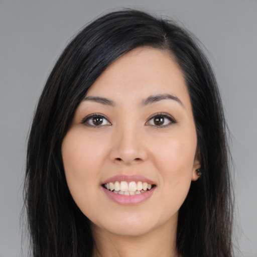 Joyful asian young-adult female with long  brown hair and brown eyes