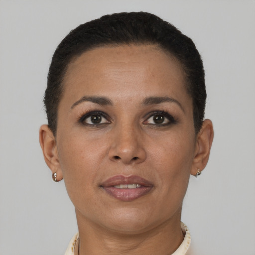 Joyful latino adult female with short  brown hair and brown eyes