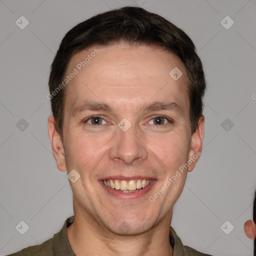 Joyful white adult male with short  brown hair and grey eyes