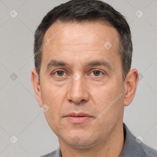 Joyful white adult male with short  black hair and brown eyes