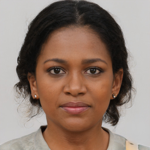 Joyful black young-adult female with medium  brown hair and brown eyes