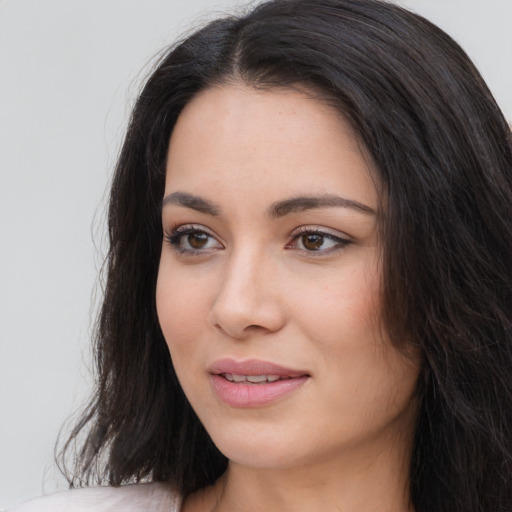 Joyful white young-adult female with long  black hair and brown eyes