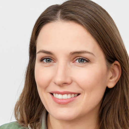 Joyful white young-adult female with long  brown hair and green eyes