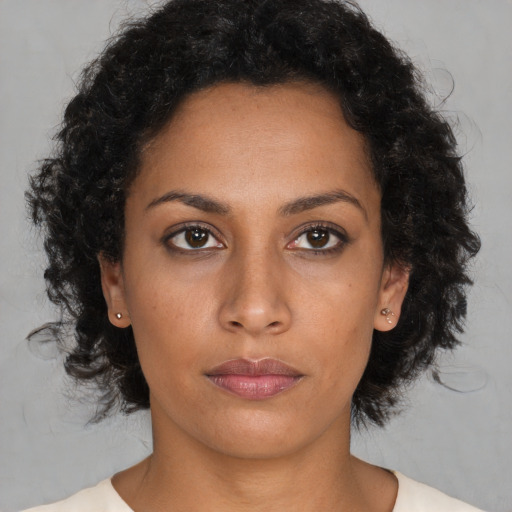 Neutral latino young-adult female with medium  brown hair and brown eyes