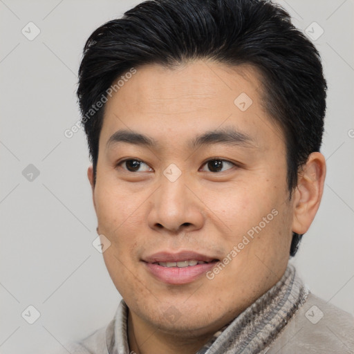 Joyful asian young-adult male with short  brown hair and brown eyes