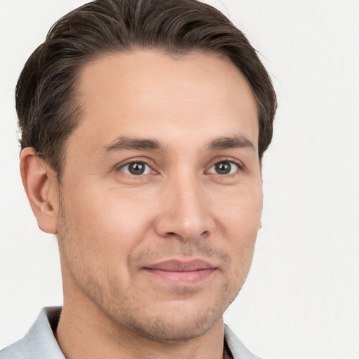 Joyful white young-adult male with short  brown hair and brown eyes