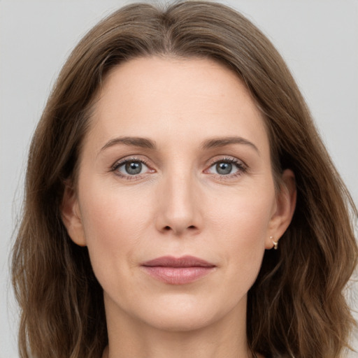 Joyful white young-adult female with long  brown hair and grey eyes