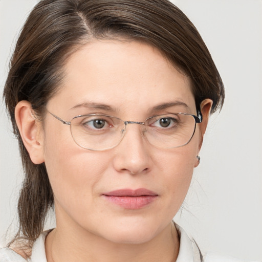 Joyful white adult female with medium  brown hair and grey eyes