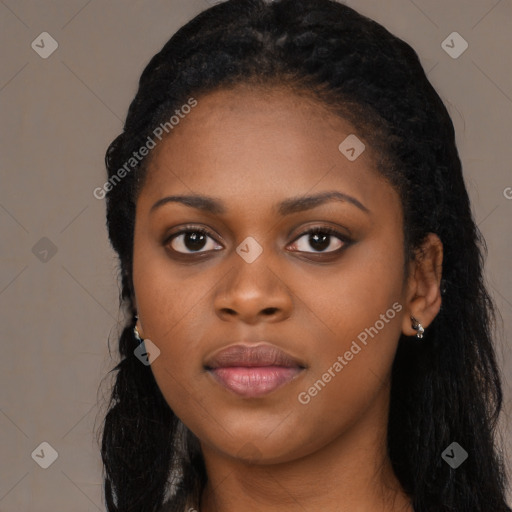 Joyful black young-adult female with long  black hair and brown eyes