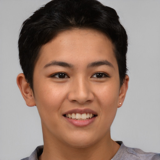Joyful asian young-adult female with short  brown hair and brown eyes