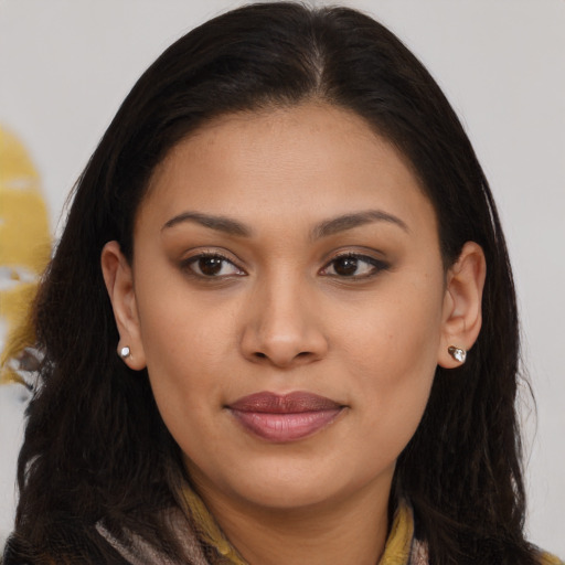 Joyful black young-adult female with long  brown hair and brown eyes