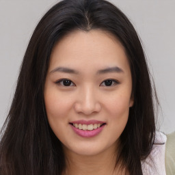 Joyful asian young-adult female with long  brown hair and brown eyes