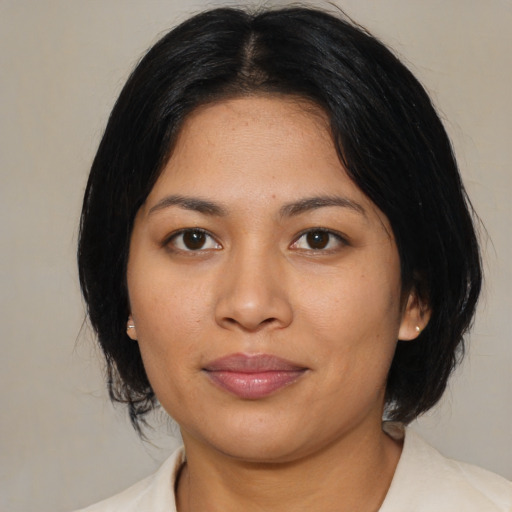 Joyful latino young-adult female with medium  black hair and brown eyes