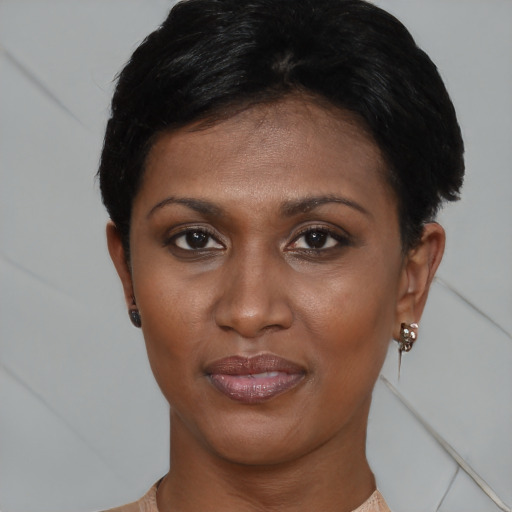 Joyful black young-adult female with short  brown hair and brown eyes