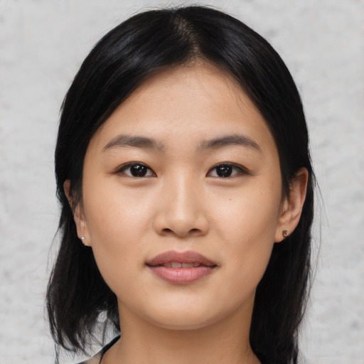 Joyful asian young-adult female with medium  black hair and brown eyes