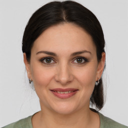 Joyful white young-adult female with medium  brown hair and brown eyes