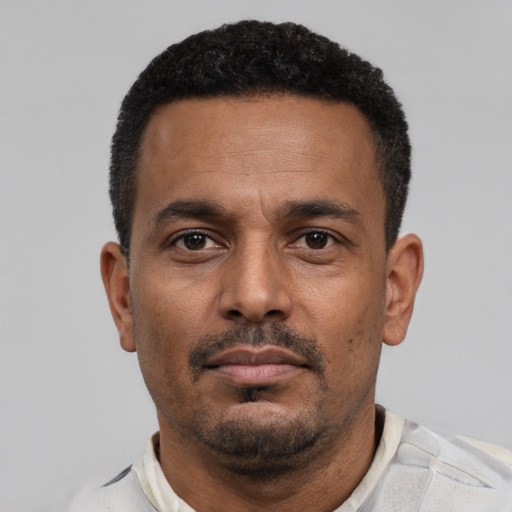 Neutral black adult male with short  black hair and brown eyes