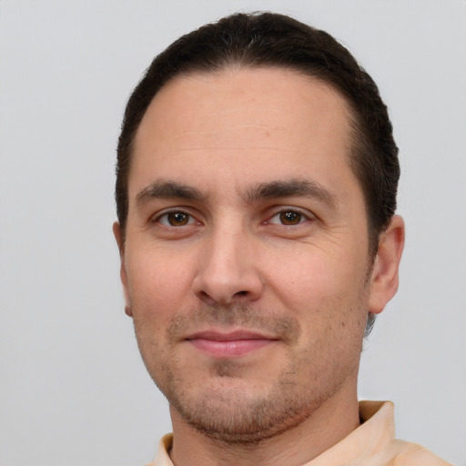 Joyful white young-adult male with short  brown hair and brown eyes