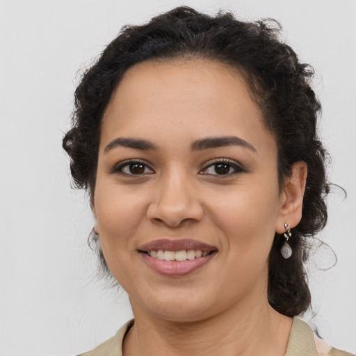 Joyful latino young-adult female with long  brown hair and brown eyes