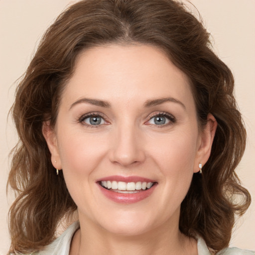 Joyful white young-adult female with medium  brown hair and green eyes