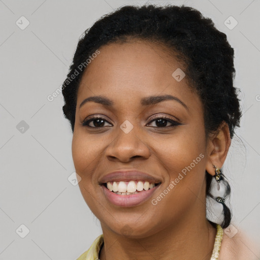 Joyful black young-adult female with long  brown hair and brown eyes