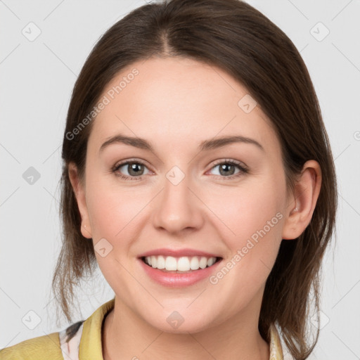 Joyful white young-adult female with medium  brown hair and grey eyes