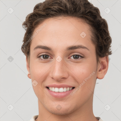 Joyful white young-adult female with short  brown hair and grey eyes