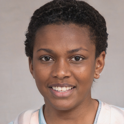Joyful black young-adult female with short  black hair and brown eyes
