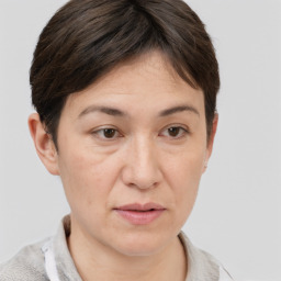 Joyful white adult female with short  brown hair and brown eyes