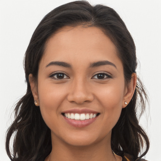 Joyful latino young-adult female with long  brown hair and brown eyes