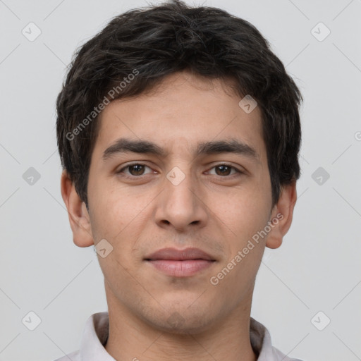 Joyful white young-adult male with short  black hair and brown eyes