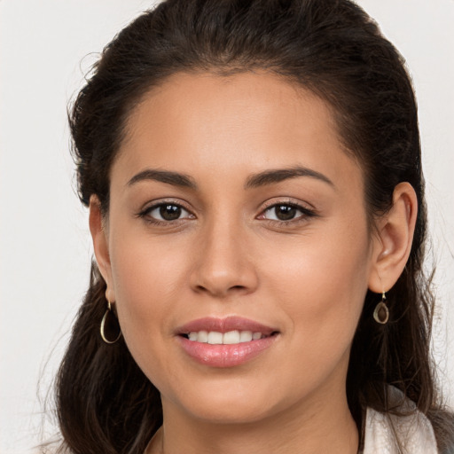 Joyful white young-adult female with long  brown hair and brown eyes