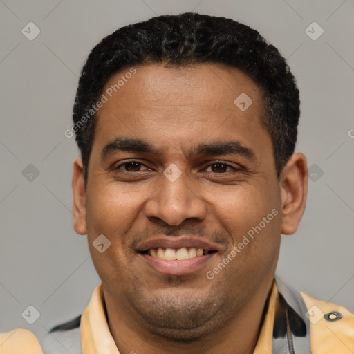 Joyful latino young-adult male with short  brown hair and brown eyes